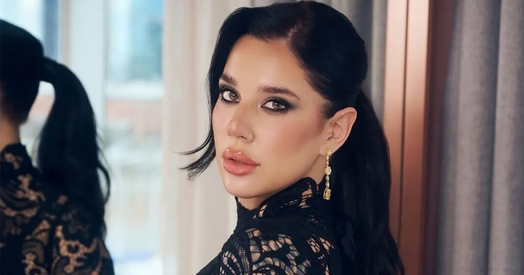 Vista del living del departamento de La Tora Villar, con un sillón naranja vibrante y decoración moderna.