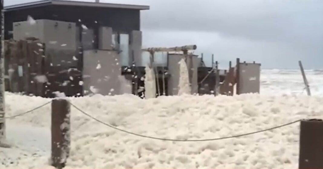 Paisaje de la costa de Quequén cubierto de espuma marina blanca que simula nieve tras la ciclogénesis